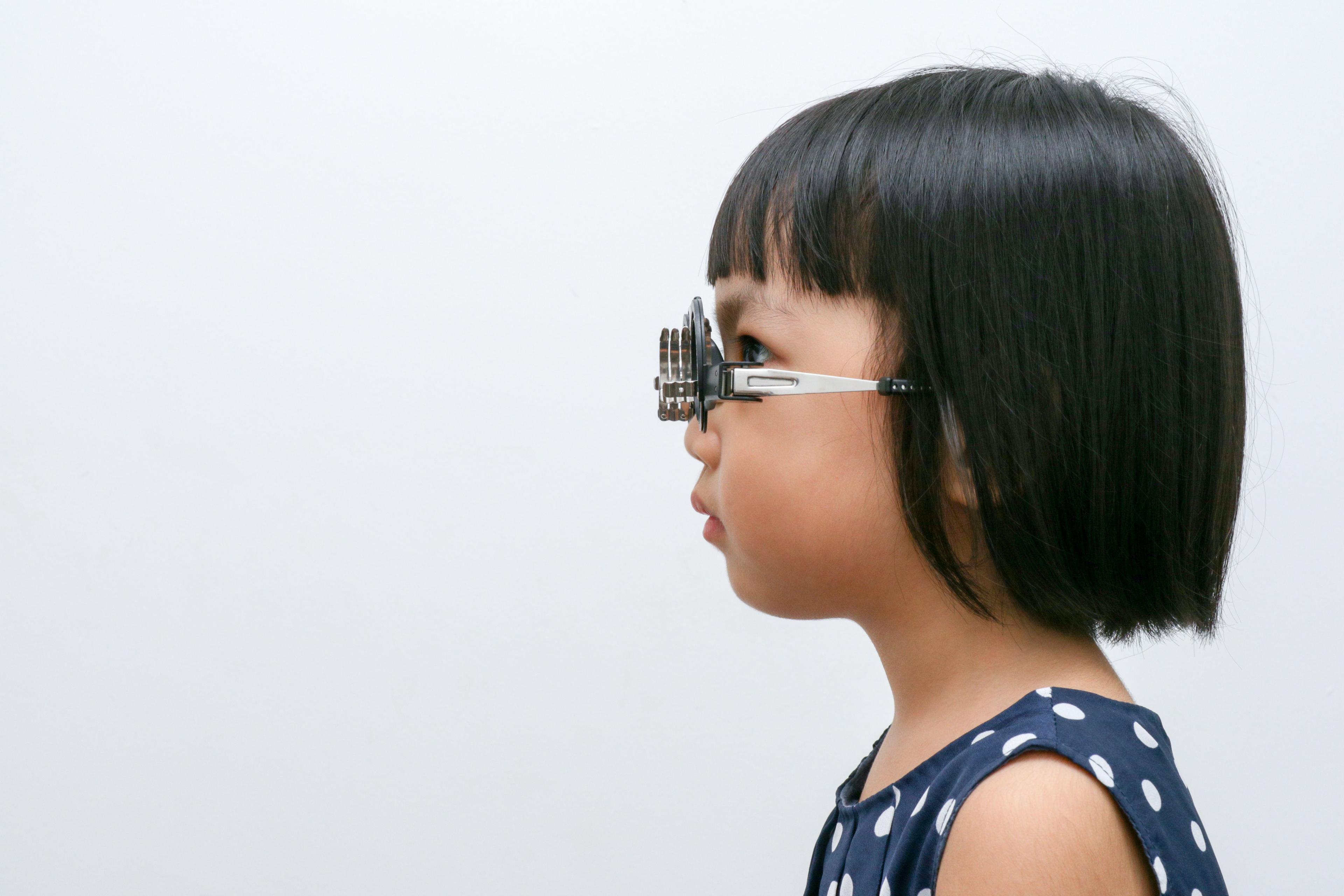 child doing refraction on white background
