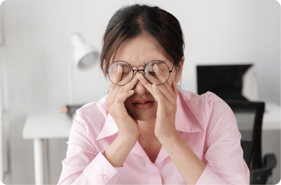 woman experiencing eye strain and irritation from pterygium causes